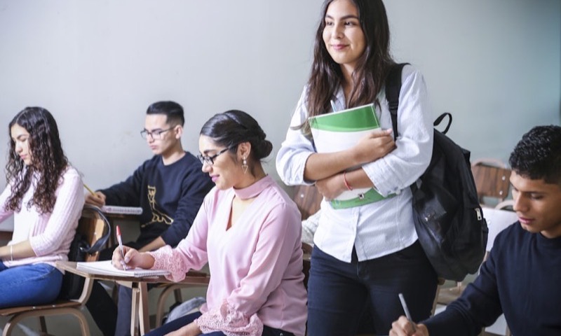 College students in a classroom with notebooks