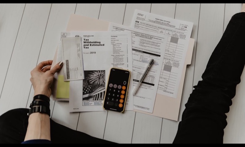 Paperwork and a calculator laid out for family budgeting