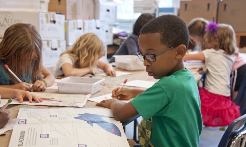 Children working at desks in a classroom